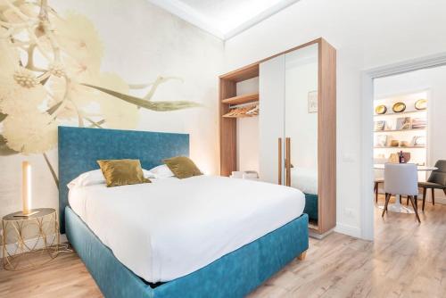 a bedroom with a large bed with a blue headboard at Wine_Home_Florence in Florence