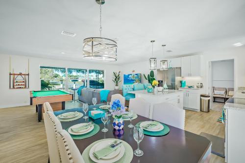 a dining room and living room with a table and chairs at Ixora16 Heated Pool, mins to beach, airport, USSSA, Cruise Port, 1h to Disney in Melbourne