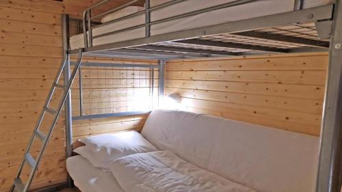 a bunk bed with a ladder in a room at Résidence Pendine 2 - Appartements pour 4 Personnes 974 in Les Prés