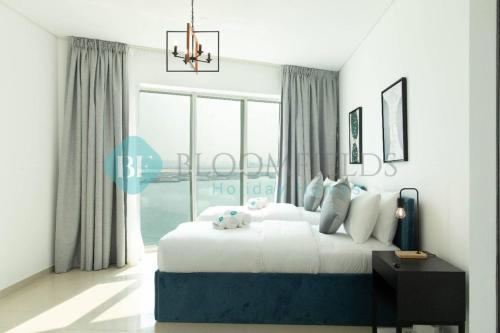 a bedroom with a bed and a large window at Relaxing 2 Bedrooms In Rak in Abu Dhabi