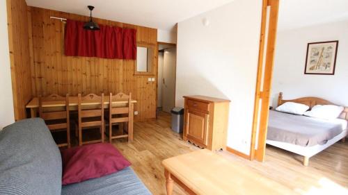 1 dormitorio con 1 cama, mesa y sillas en Résidence Dame Blanche - 2 Pièces pour 6 Personnes 374, en Narreyroux