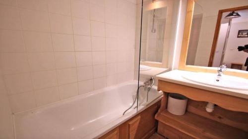a bathroom with a tub and a sink and a shower at Résidence Dame Blanche - 2 Pièces pour 6 Personnes 404 in Narreyroux