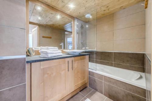La salle de bains est pourvue d'une baignoire, d'un lavabo et d'une baignoire. dans l'établissement Résidence Les Balcons EtoilÉs - Appartement 4 au pied des pistes MAE-3269, à Champagny-en-Vanoise
