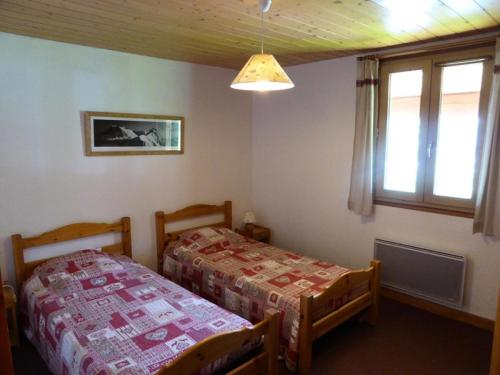 une chambre avec deux lits et une fenêtre dans l'établissement Résidence Le Valmorel - Le Valmorel -Chalet individuel, cadre reposant avec une magnifique vue MAE-4684, à Valmorel