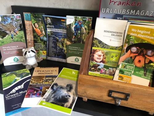 a wooden box filled with lots of publications at Ja, das gönn' ich mir. Sauna, Natur - alles hier. in Neudrossenfeld