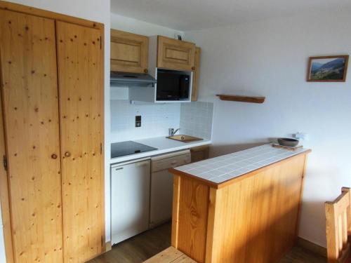 - une petite cuisine avec des placards en bois et un comptoir dans l'établissement Résidence Le Chardonnet - 2 Pièces pour 6 Personnes MAE-3310, à Champagny-en-Vanoise