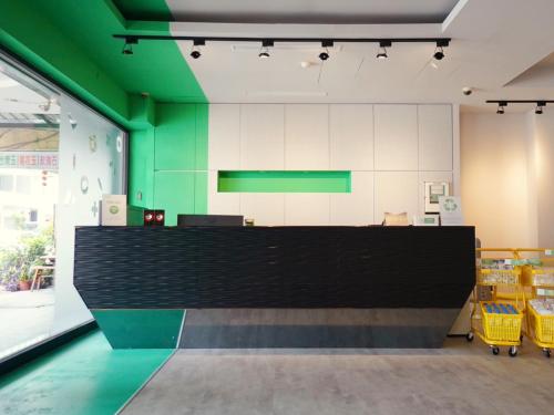 a large counter in a store with a green wall at together hotel-Hualien Zhongshan in Hualien City