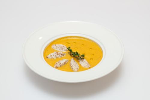 a bowl of soup on a white table at Aristokrat in Vinnytsya