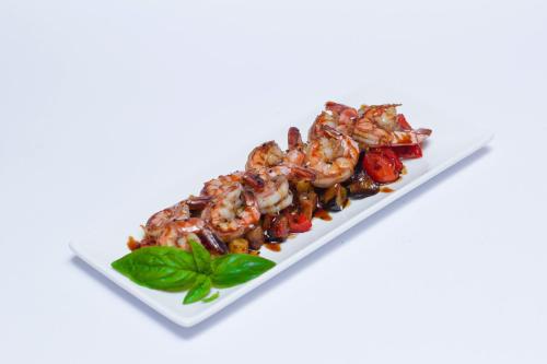 a white plate of food with shrimp and vegetables at Aristokrat in Vinnytsya