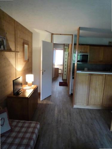 Cette chambre comprend un lit, un bureau et une cuisine. dans l'établissement Résidence Pierrafort - Pierrafort 31 - Agréable 2 pièces au pied des pistes, classé 3 étoiles MAE-1944, à Valmorel