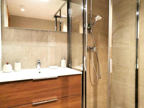 a bathroom with a sink and a shower at Résidence Lumi - Lumi - Le Logis de Valmo - Magnifique 3 pièces, calme et chaleureux MAE-1894 in Le Fey