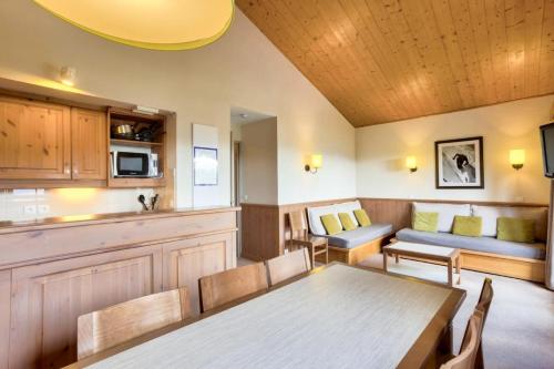 a living room with a table and a couch at Quartier La Forêt - maeva Home - Appartement 3 pièces 7 personnes - Sélection MAE-7024 in Valmorel