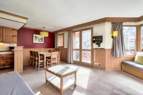 a living room with a couch and a table at Quartier La Forêt - maeva Home - Appartement 3 pièces 7 personnes - Sélection MAE-7124 in Valmorel