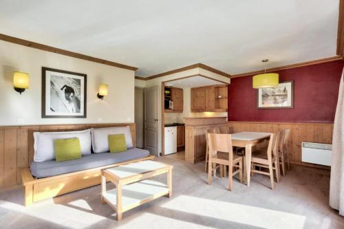 a living room with a couch and a table at Quartier La Forêt - maeva Home - Appartement 3 pièces 7 personnes - Sélection MAE-7124 in Valmorel
