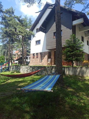 a group of hammocks in front of a house at Vila Plamenac in Divčibare