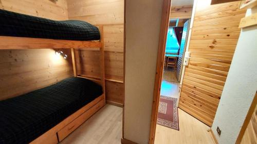 a small room with two bunk beds and a mirror at MUCILLON G - Appartement MUCILLON 794 in Valmorel