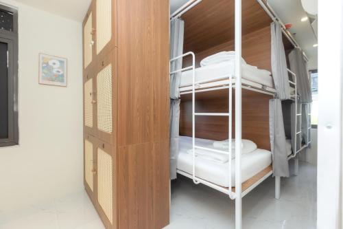 a room with two bunk beds and a closet at The Backpacker Hostel and spa in Da Nang