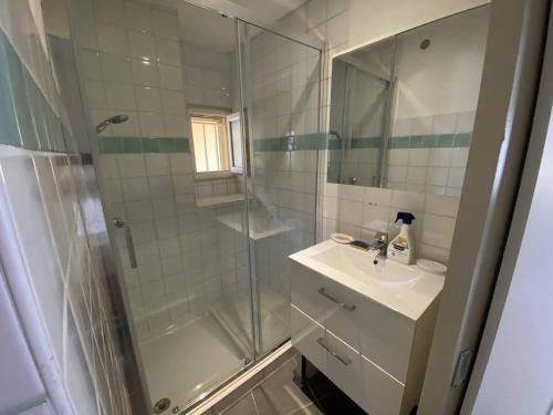 une salle de bain avec une douche en verre et un lavabo dans l'établissement Vue mer au coeur de Saint Mandrier, 3 chambres, climatisation, wifi (fibre), à Saint-Mandrier-sur-Mer