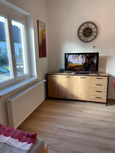 a living room with a flat screen tv on a dresser at Wohnungen Bachhaus in Traun