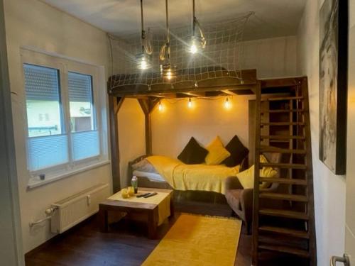 a bedroom with a bunk bed and a stairwell at Wohnungen Bachhaus in Traun