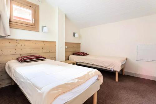 a room with two beds and a chalkboard in it at Résidence Plagne Lauze - maeva Home - Appartement 3 pièces 7 personnes - S 954 in Mâcot La Plagne