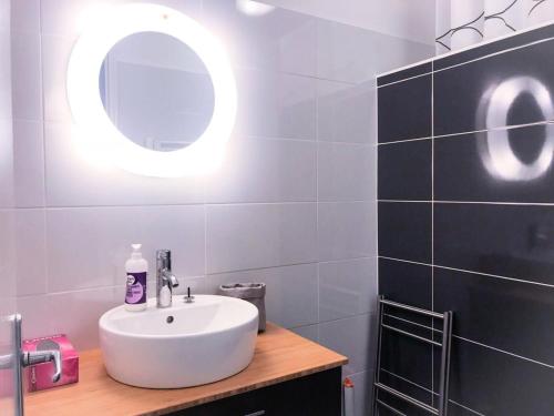 uma casa de banho com um lavatório branco e um espelho. em Résidence Cimes - 2 Pièces pour 6 Personnes 324 em Vénosc