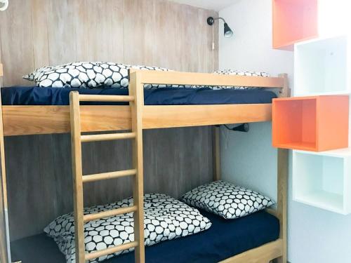 two bunk beds with pillows on them in a room at Résidence Cote Brune 2 - Studio pour 4 Personnes 394 in Vénosc