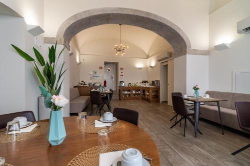 a dining room and living room with a table and chairs at Templo Boutique Hotel in Évora