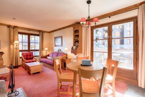a living room with a table and a couch at Résidence Les Arcs Le Village - maeva Home - Appartement pièces - Prestige 204 in Bourg-Saint-Maurice