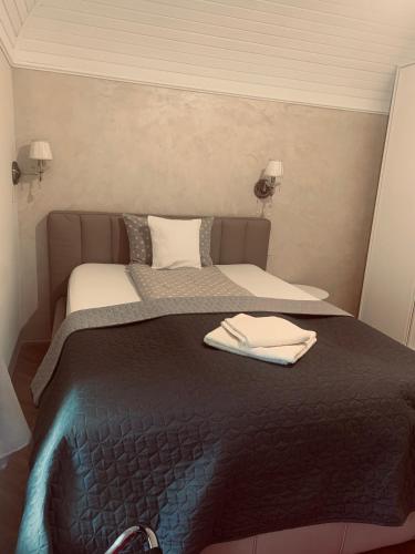 a bedroom with a bed with a black blanket at La Casa Tamaris in Senta