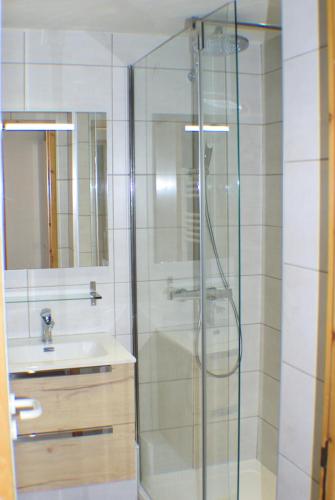 une salle de bain avec une douche en verre et un lavabo dans l'établissement Résidence Le Hameau du Sauget - maeva Home - Appartement 4 pièces 7 personnes - Sélection MAE-4354, à La Plagne Tarentaise