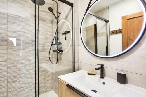 a bathroom with a sink and a mirror at Résidence Les Arcs Le Village - maeva Home - Appartement pièces - Prestige 711 in Arc 1950