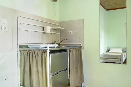 a small kitchen with a sink and a mirror at Old Boat double studio 8 in Nikiana