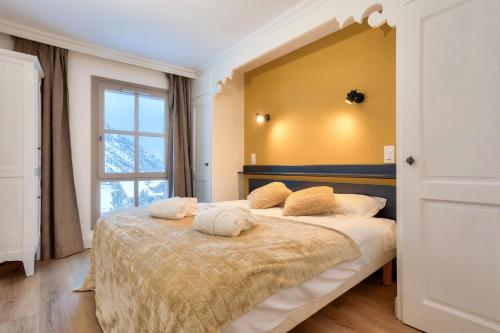 une chambre avec un lit avec deux oreillers dessus dans l'établissement Résidence Les Arcs 1950 Le Village - maeva Home - Appartement 2 pièces 4 personnes - Prestige MAE-9761, à Arc 1950