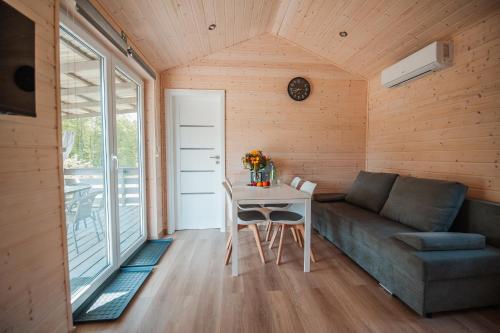 a living room with a couch and a table at Siedlisko13 in Mrągowo