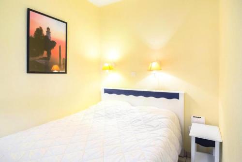 - une chambre avec un lit blanc et deux lumières dans l'établissement Résidence Port Bourgenay - maeva Home - 2 Pièces 5 Personnes Confort MAE-1078, à Talmont-Saint-Hilaire