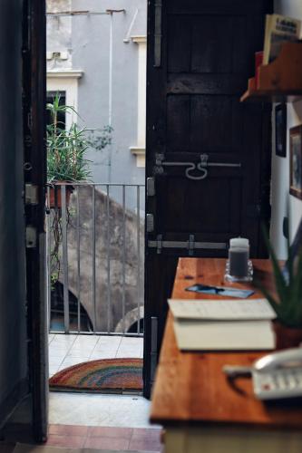 an open door to a room with a desk and a table at Cataneasy Rooms in Catania