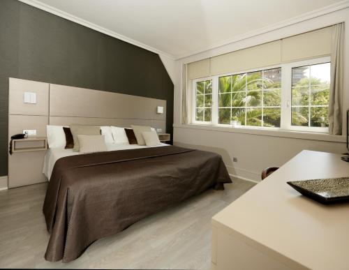 En eller flere senge i et værelse på Hotel Igeretxe
