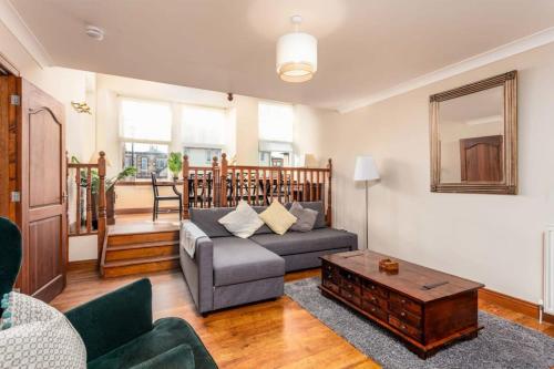 a living room with a couch and a coffee table at Cromwell Corner - Donnini Apartments in Ayr