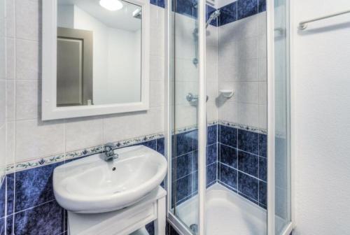 une salle de bain avec un lavabo et une douche en verre dans l'établissement Résidence le Hameau des Issambres - maeva Home - 2 Pièces 6 Personnes Sélection MAE-1296, aux Issambres