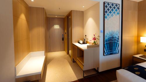 a hotel room with a bed and a bathroom at Courtyard by Marriott Vadodara in Vadodara