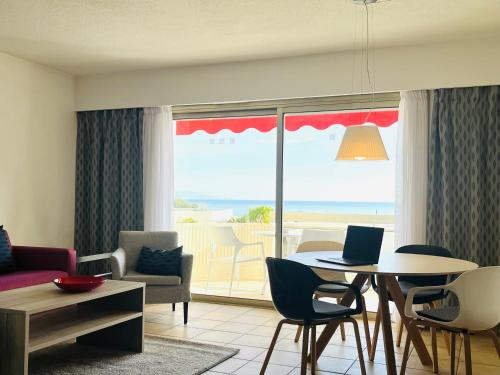 a living room with a table with a laptop on it at Hapimag Apartments Antibes in Antibes