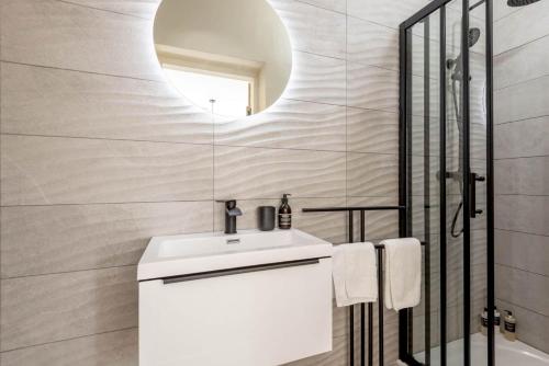 a bathroom with a white sink and a mirror at Firthview - Crail in Anstruther