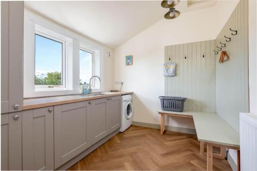 a kitchen with a sink and a washing machine at Firthview - Luxury 4 Bed 4 Bath - near Cow Shed in Anstruther