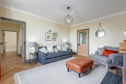 a living room with a couch and a chair at Firthview - Crail in Anstruther