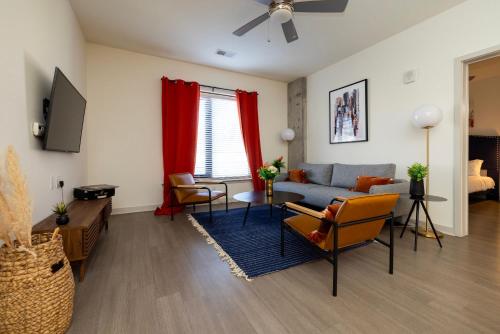 a living room with a couch and a table at Modern Nulu 2BR CozySuites 03 in Louisville