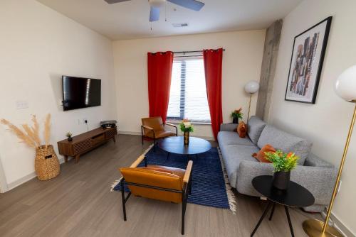 a living room with a couch and a table at Modern Nulu 2BR CozySuites 03 in Louisville