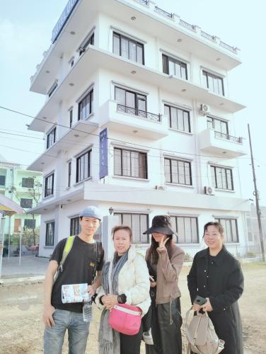 a group of people standing in front of a building at HOTEL OCEAN in Lumbini