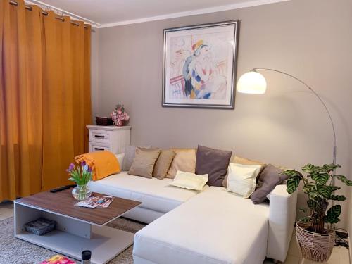 a living room with a white couch and a table at Wohnung mitten in der Altstadt in Koblenz