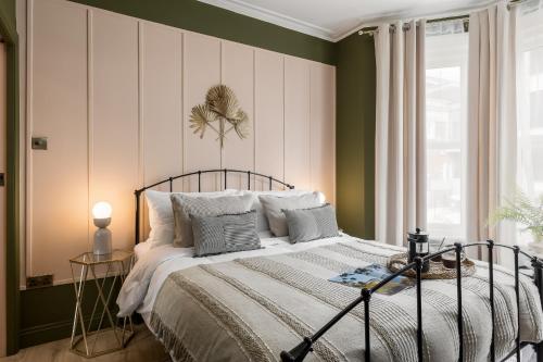 a bedroom with a bed with green and white stripes at Stylish Central Apartment in Bournemouth